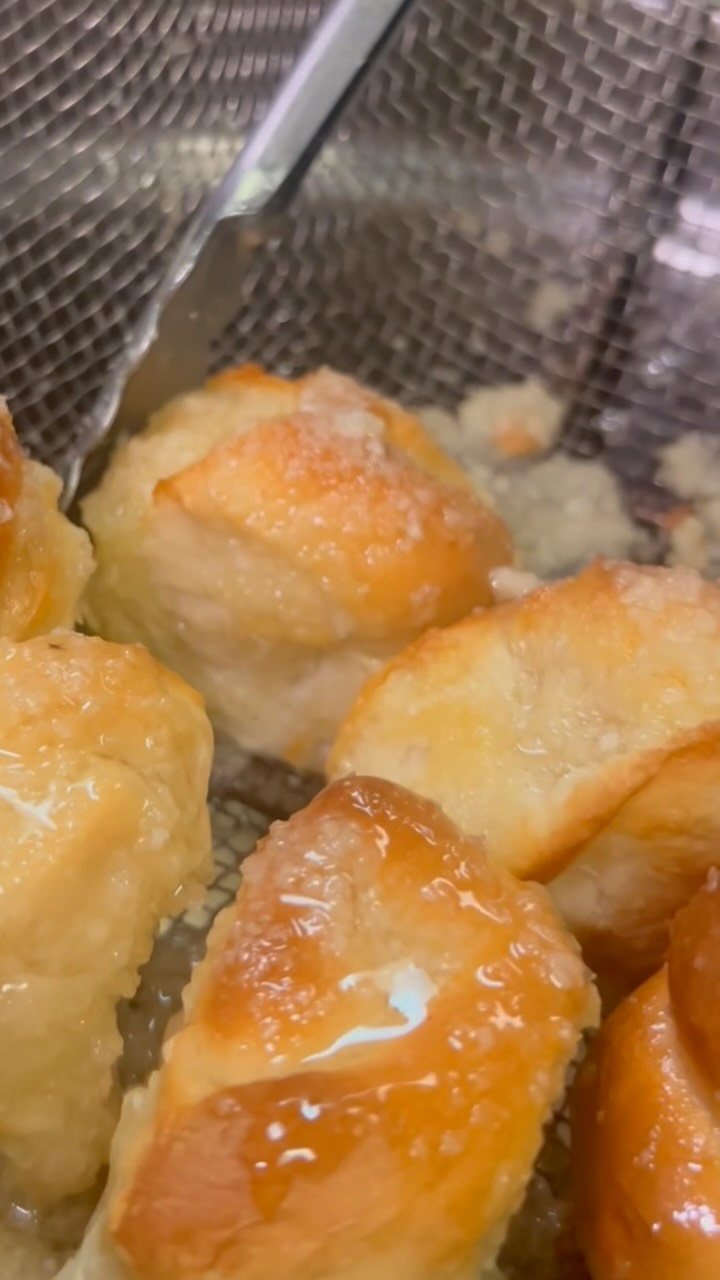Glossy homemade garlic knots fresh on the pan