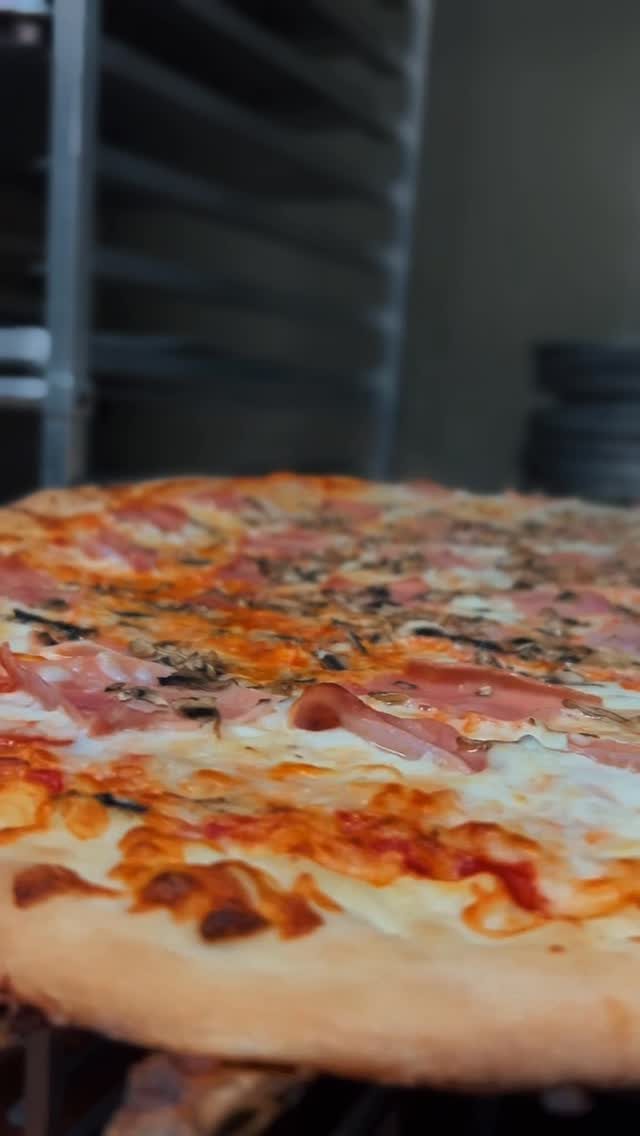 Pizza on the peel, fresh from the oven