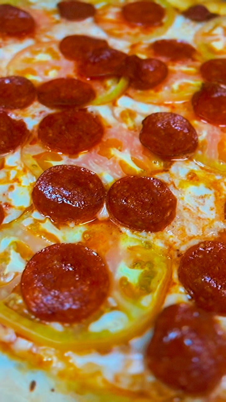 Close crop of Steve's Special pizza with peppers, onions, mushrooms and pepperoni
